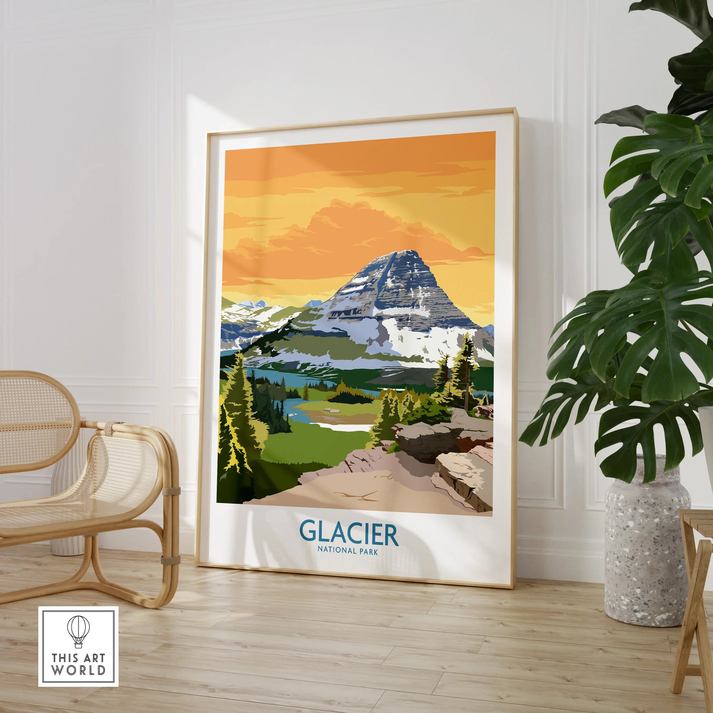 Framed Glacier National Park travel poster with mountain art in a modern room with chair and plant