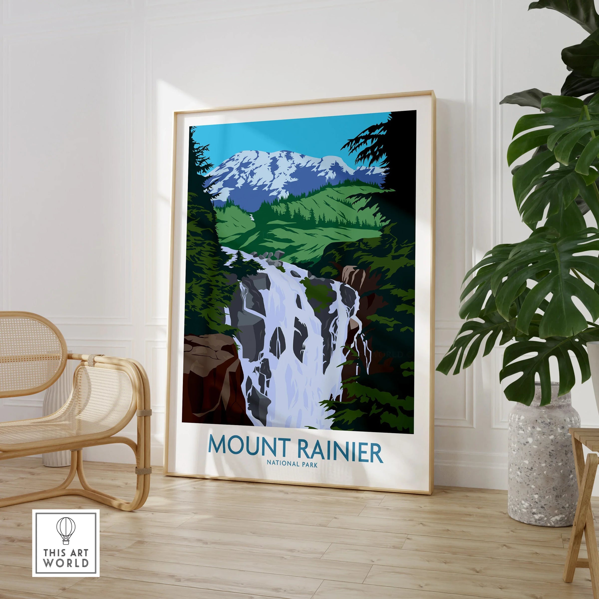 Framed Mount Rainier National Park wall art with waterfall in modern room, near chair and plant.