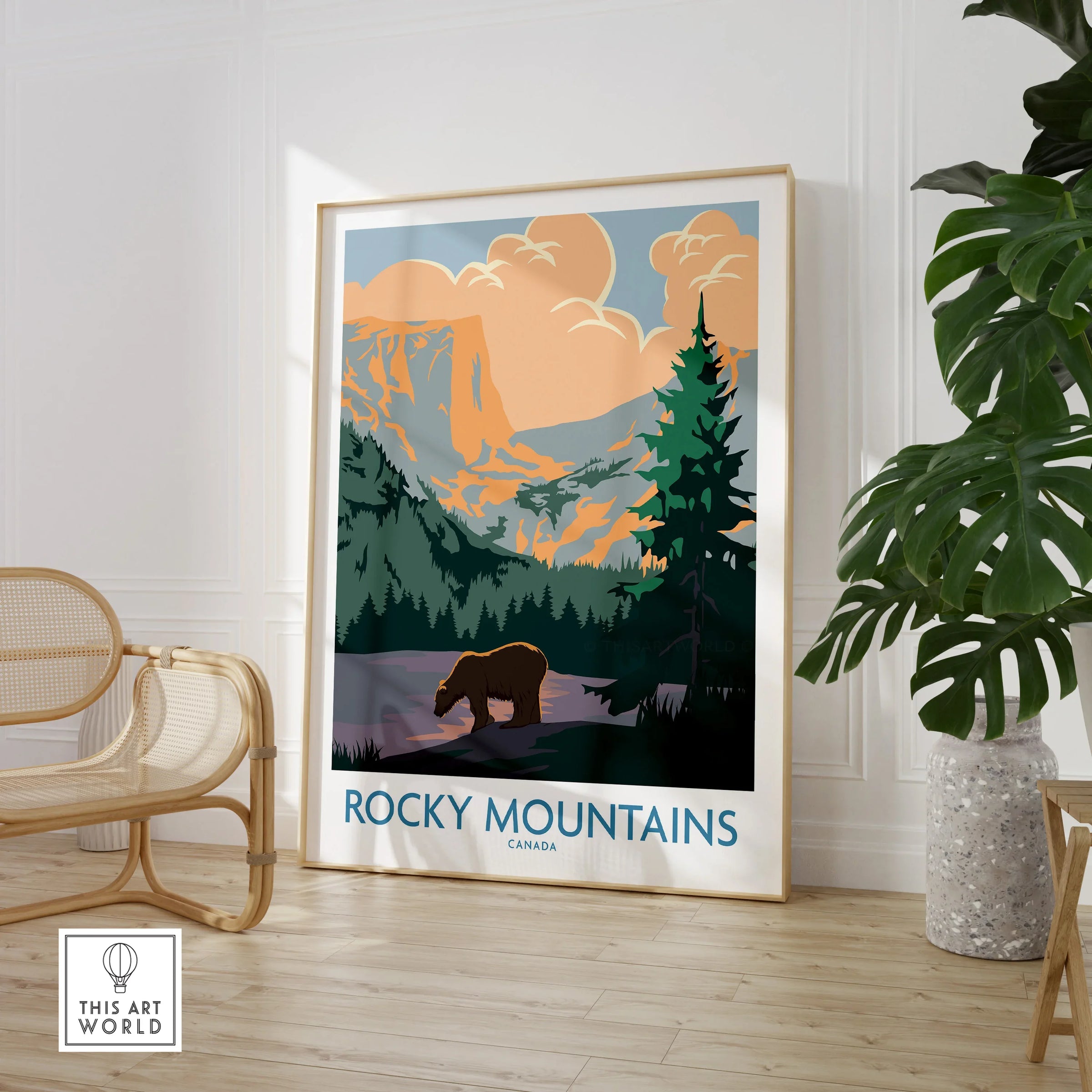 Rocky Mountains Canada travel poster with bear, displayed in modern room with chair and plant