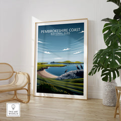 Pembrokeshire Coast National Park travel poster framed on floor, modern room with chair and plant