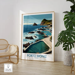 Framed Porto Moniz travel poster with ocean view, displayed in modern room with chair and plant