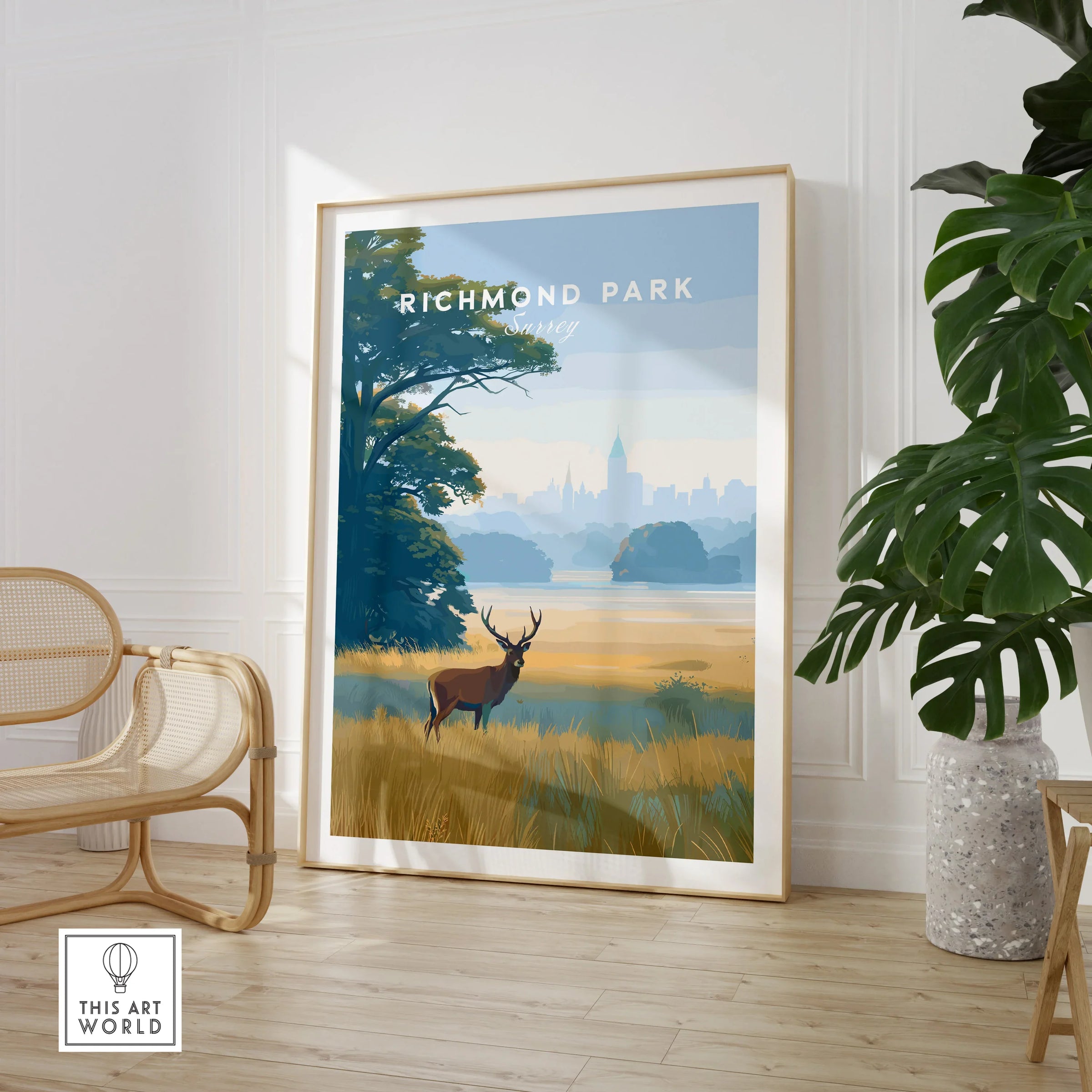 Framed Richmond Park travel poster with deer, in a modern room with chair and plant