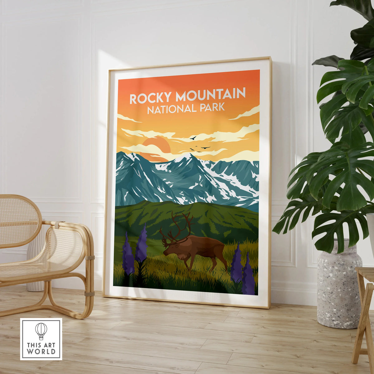 Rocky Mountain National Park art print in modern room with chair and green plant