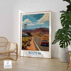 Framed Route 66 travel poster with classic car, desert landscape, and mountains, styled in modern room