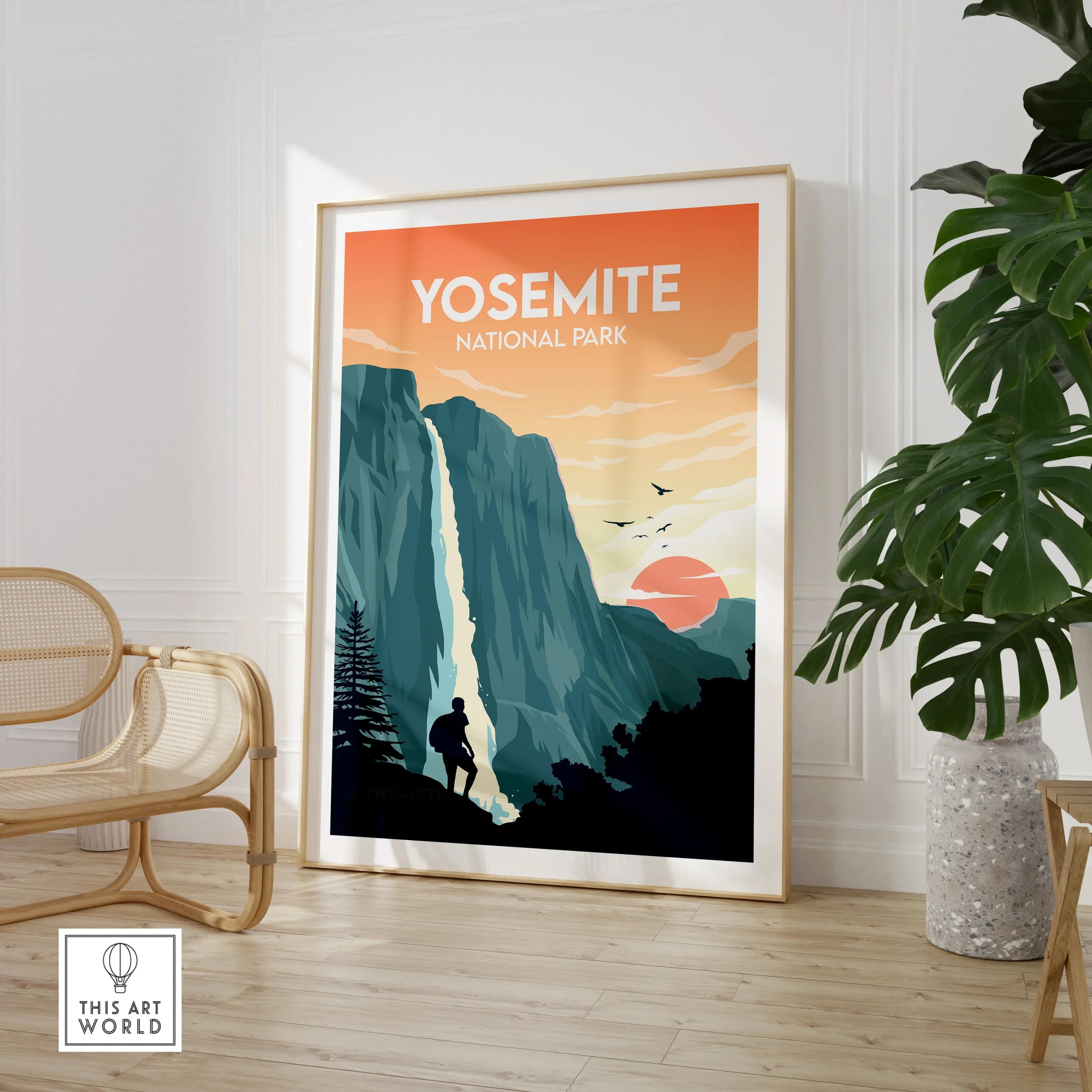 Framed Yosemite National Park wall art by a chair and potted plant in a modern room
