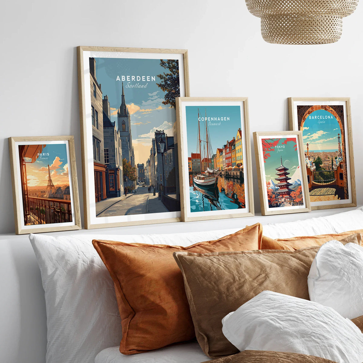 Framed travel posters of Paris, Aberdeen, Copenhagen, Tokyo, and Barcelona for wall art decor