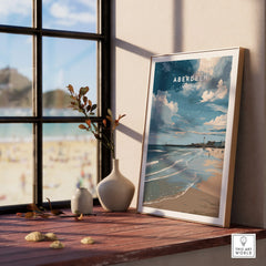 Aberdeen Scotland travel poster print with beach, lighthouse, and sky, displayed on a windowsill for home decor