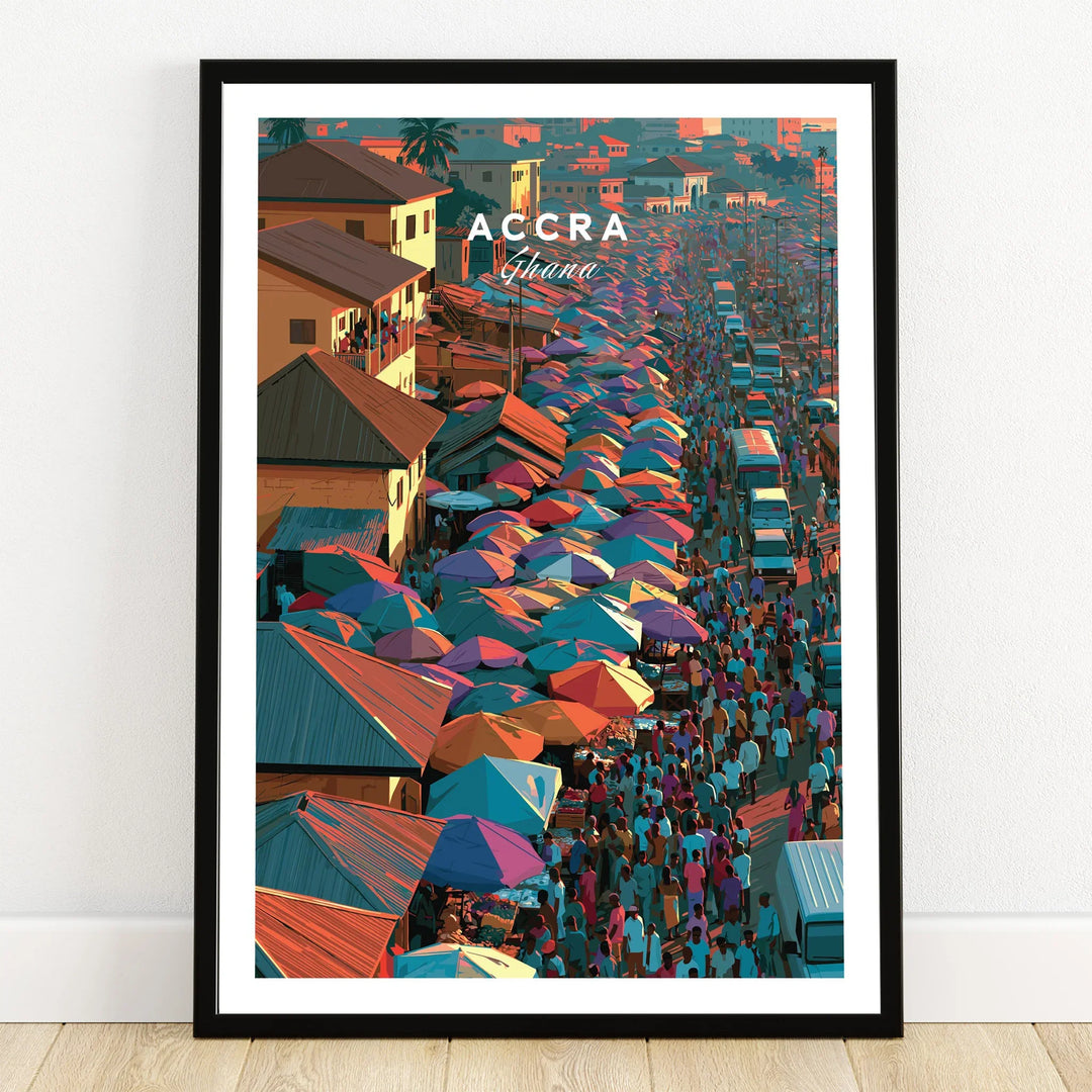 Accra Ghana market street travel poster with colourful umbrellas in a black frame on a wooden floor
