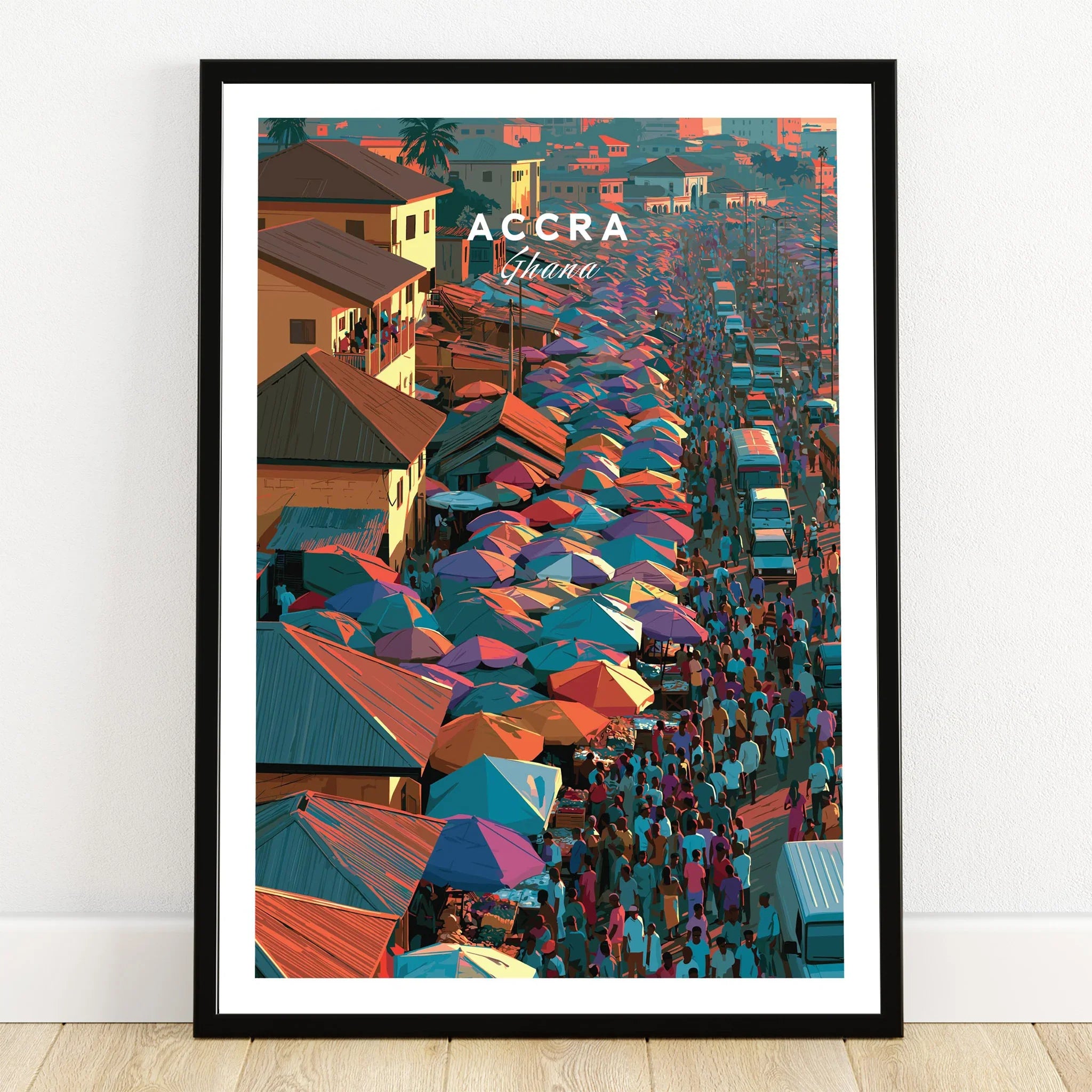 Accra Ghana market street travel poster with colourful umbrellas in a black frame on a wooden floor