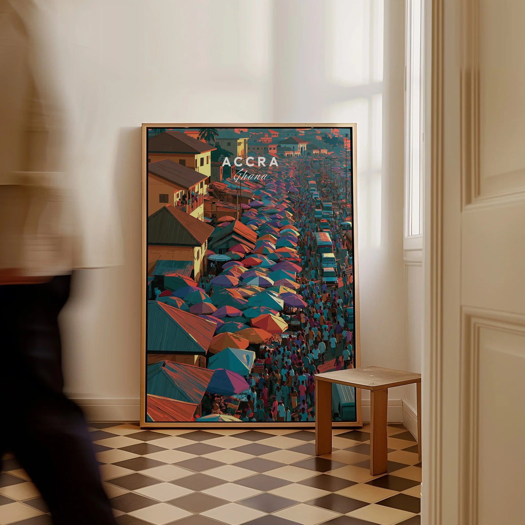 Accra Ghana framed canvas travel poster on the floor with a man walking past