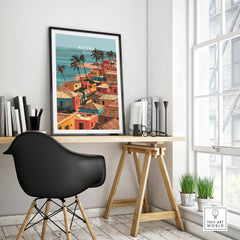 Accra Ghana coastal village poster in a black frame on a modern office desk