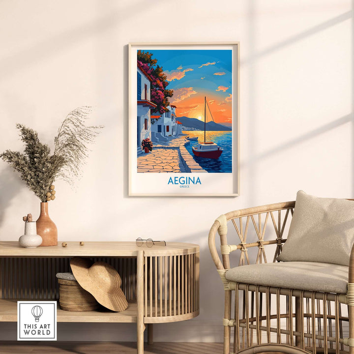 Aegina Greece travel poster featuring a sunset and boat, displayed in a cozy interior setting with rattan furniture.