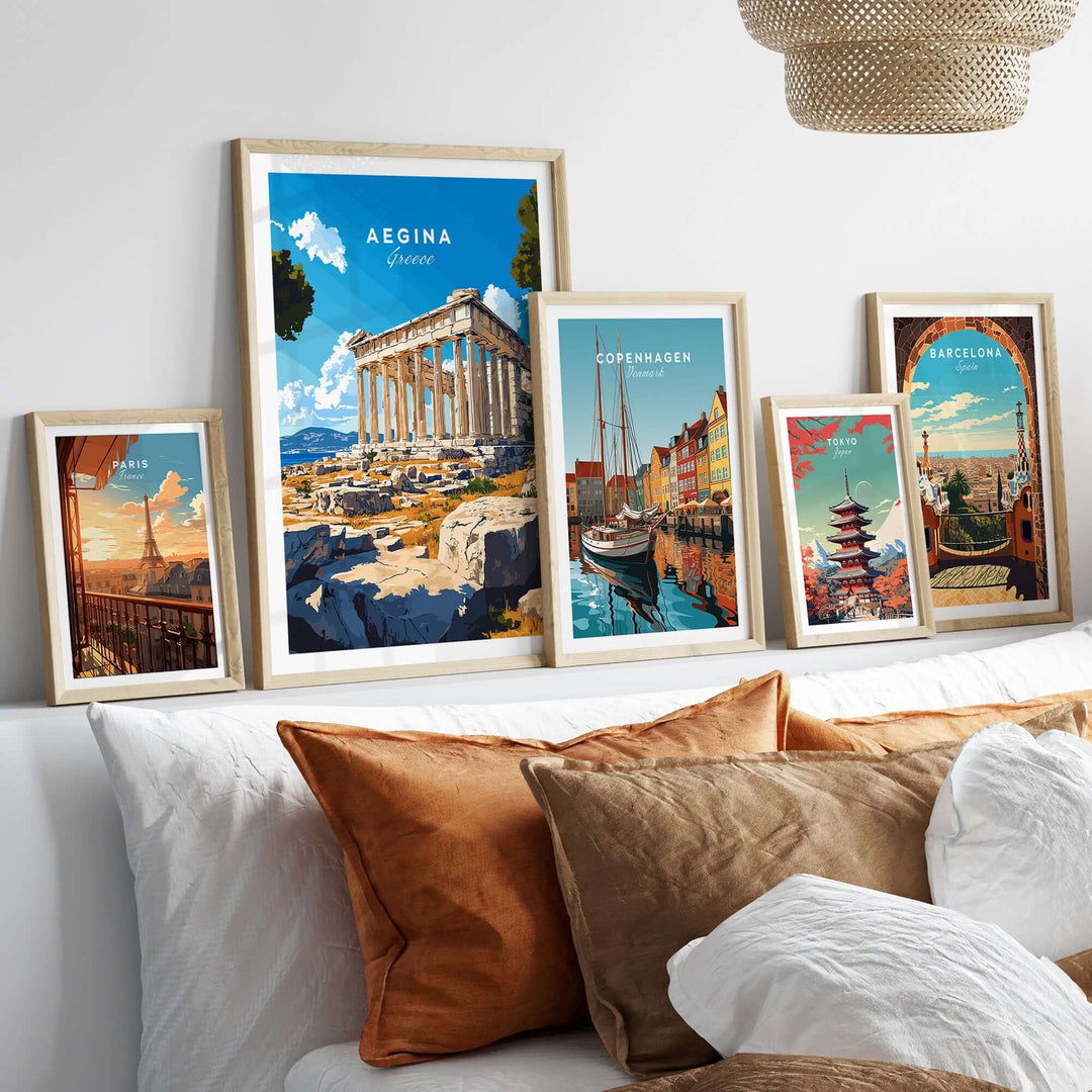 Aegina Print Greece displayed among vibrant travel art prints on a cozy bed, adding a touch of culture to home decor.