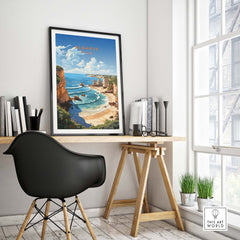 Algarve beach print framed in a minimalist workspace, showcasing a coastal landscape with vibrant colors.