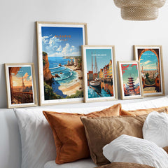 Collection of vibrant travel posters including Algarve Beach, Copenhagen, and Barcelona displayed on a cozy wall.