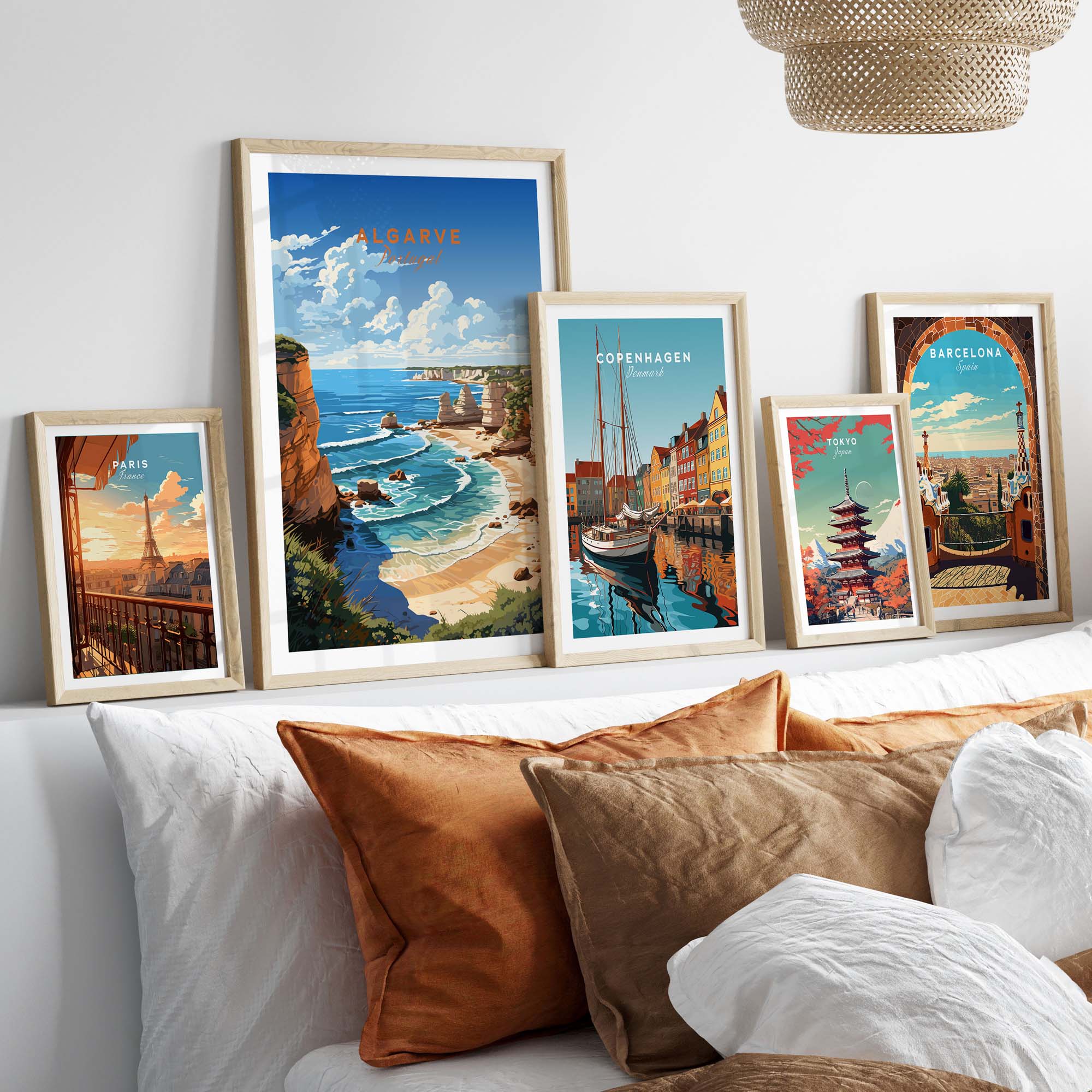 Collection of vibrant travel posters including Algarve Beach, Copenhagen, and Barcelona displayed on a cozy wall.