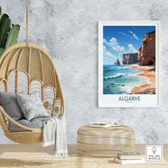 Algarve print beach poster displayed in a modern interior with a rattan chair and decor, showcasing stunning coastal views.
