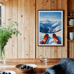 Alpe d'Huez Wall Art featuring breathtaking snowy mountains and ski gear in a cozy wooden setting.