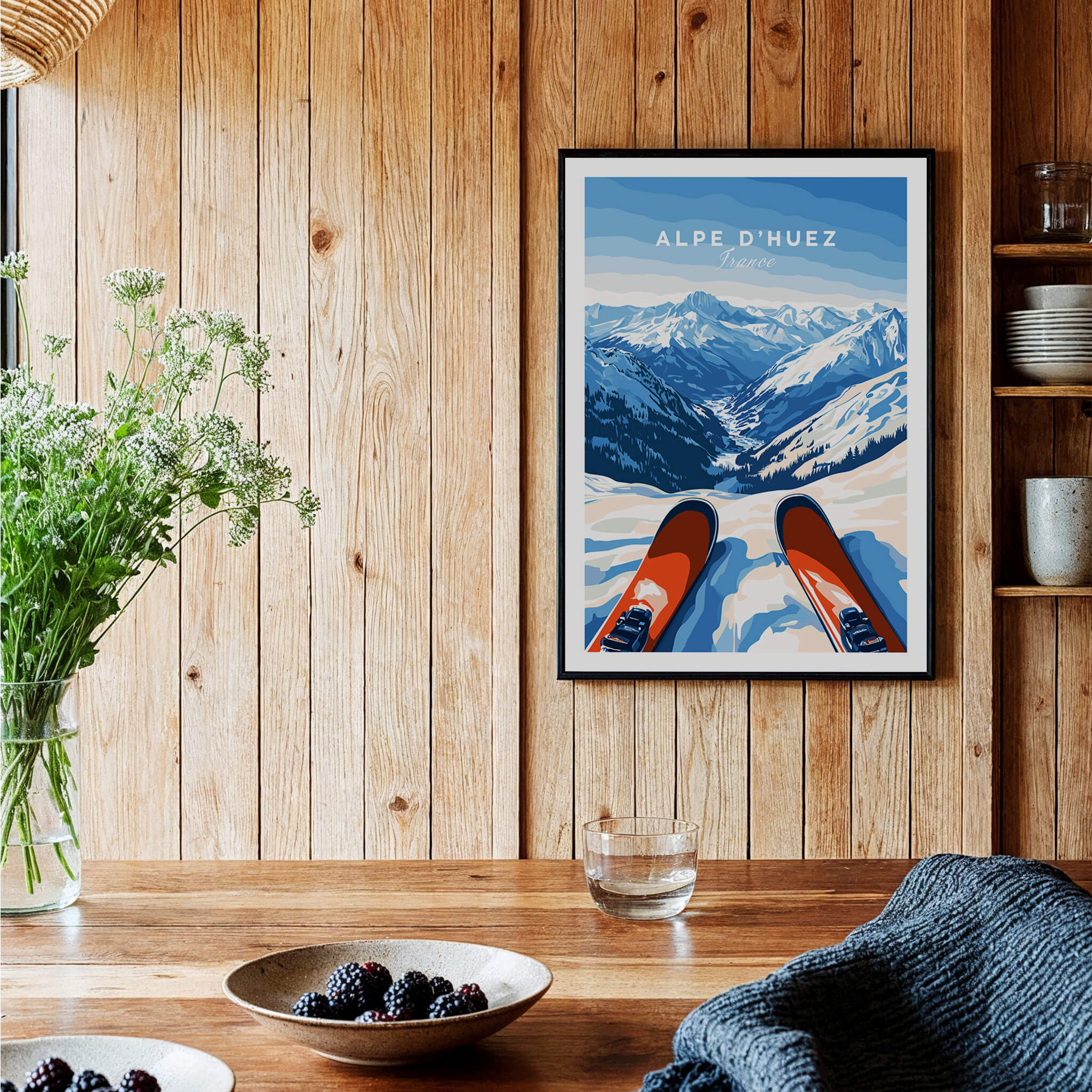 Alpe d'Huez Wall Art featuring breathtaking snowy mountains and ski gear in a cozy wooden setting.
