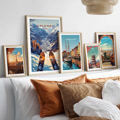 Alpe d'Huez Ski Print framed among cityscape prints on a cozy sofa, showcasing ski art for home decor enthusiasts.
