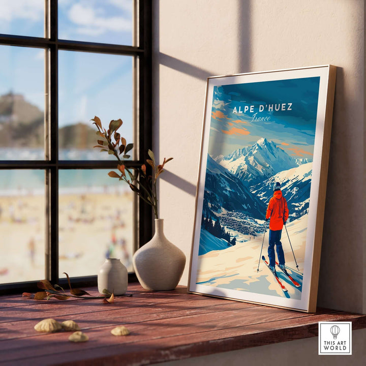 Vibrant Alpe d'Huez ski print framed on a table near a window, capturing stunning mountain views and adventure.