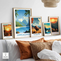Framed national park travel posters on a wall above a couch with pillows, featuring American Samoa, Yellowstone, Saguaro, Lake Clark, and Great Smoky Mountains prints.