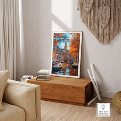 Amsterdam Canal Print - Urban Landscape Wall Decor displayed in a cozy living room setting with wooden decor.