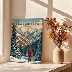 Arapahoe Basin Wall Art depicting a skier in a snowy landscape with mountains, perfect for outdoor enthusiasts.