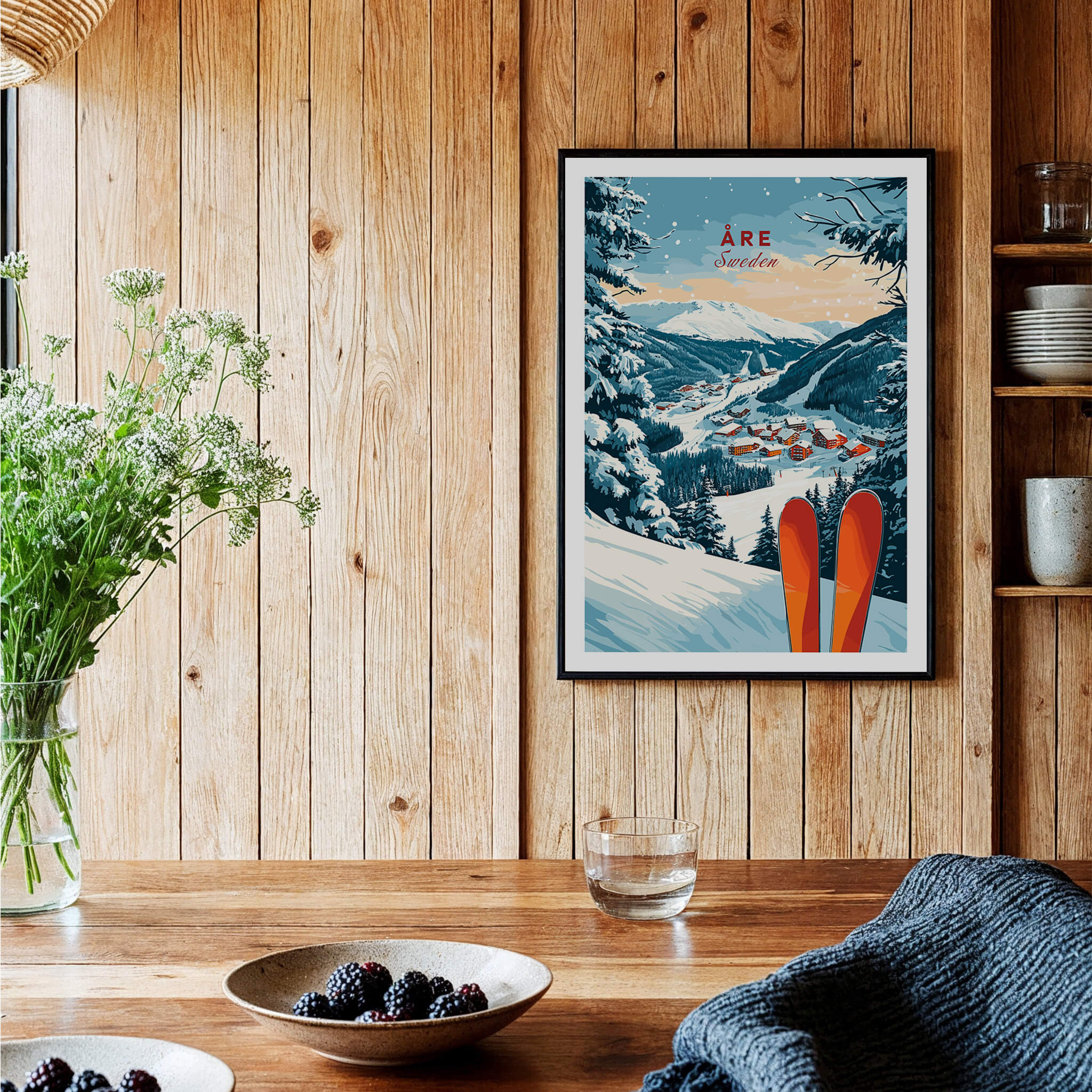 Åre Sweden Ski Print art displayed in a cozy interior featuring snow-covered mountains and vibrant red skis.