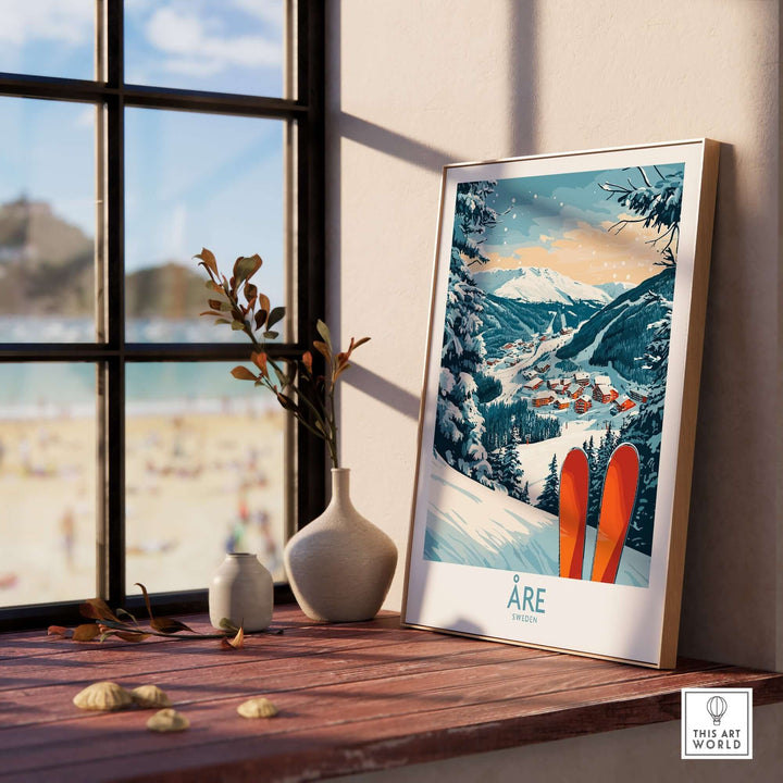 Åre Sweden ski poster displayed on a windowsill, showcasing snowy mountains and ski vibes in a cozy setting.