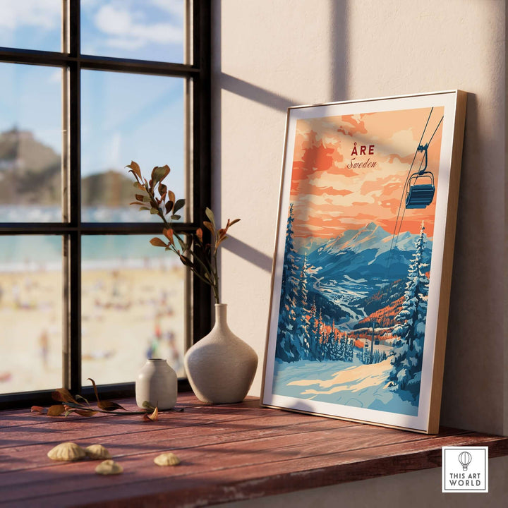 Åre Sweden wall art ski print displayed on a wooden table by a window, showcasing picturesque mountain scenery.