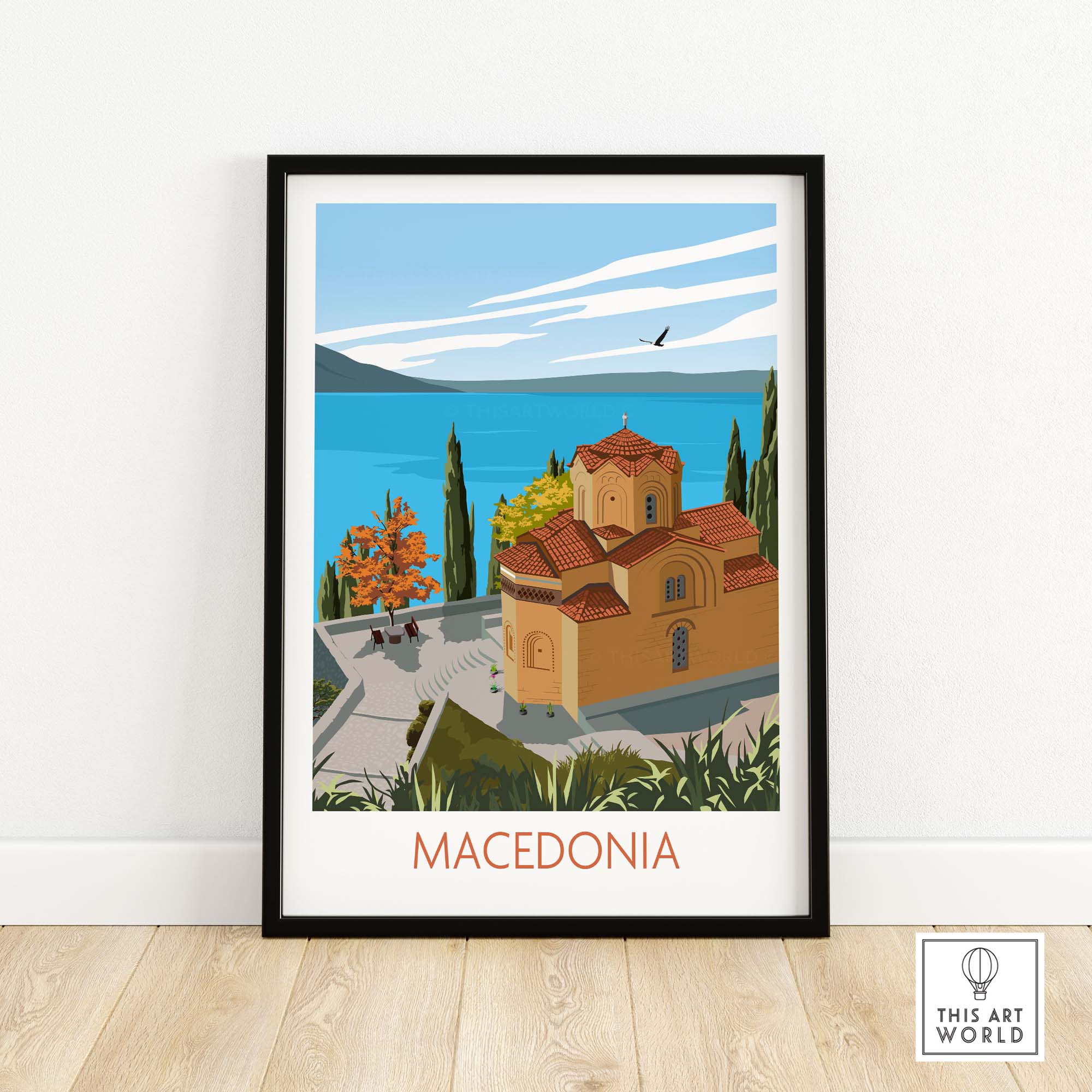 Macedonia wall art print featuring a scenic view of a church by a lake surrounded by greenery.