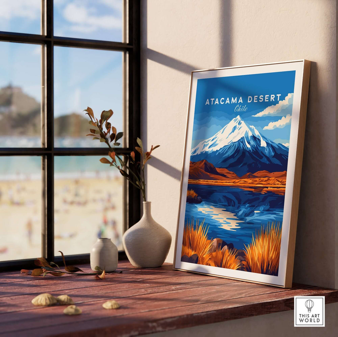 Atacama Desert travel print framed on a table next to a vase, showcasing vibrant landscape and mountain reflections.