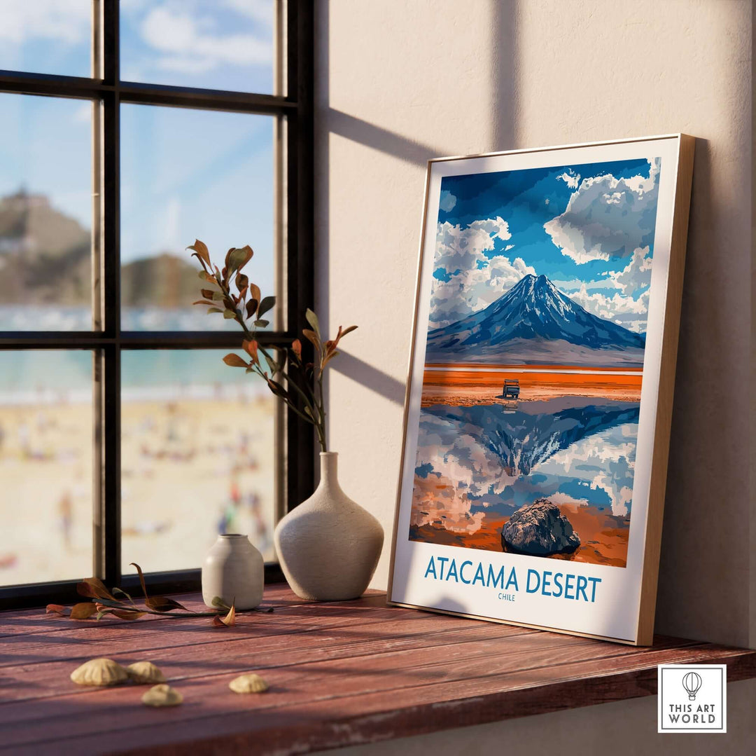 Atacama Desert travel poster displayed on a windowsill, showcasing vibrant colors and stunning mountain reflection.