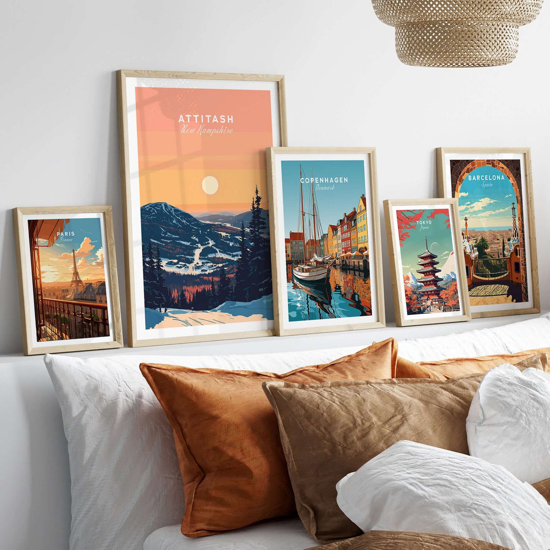 Framed Attitash Print and other city art prints displayed on a stylish wall above a cozy bed with decorative pillows.