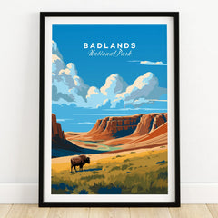 Framed Badlands National Park art print with bison, canyon cliffs, and blue sky on wooden floor