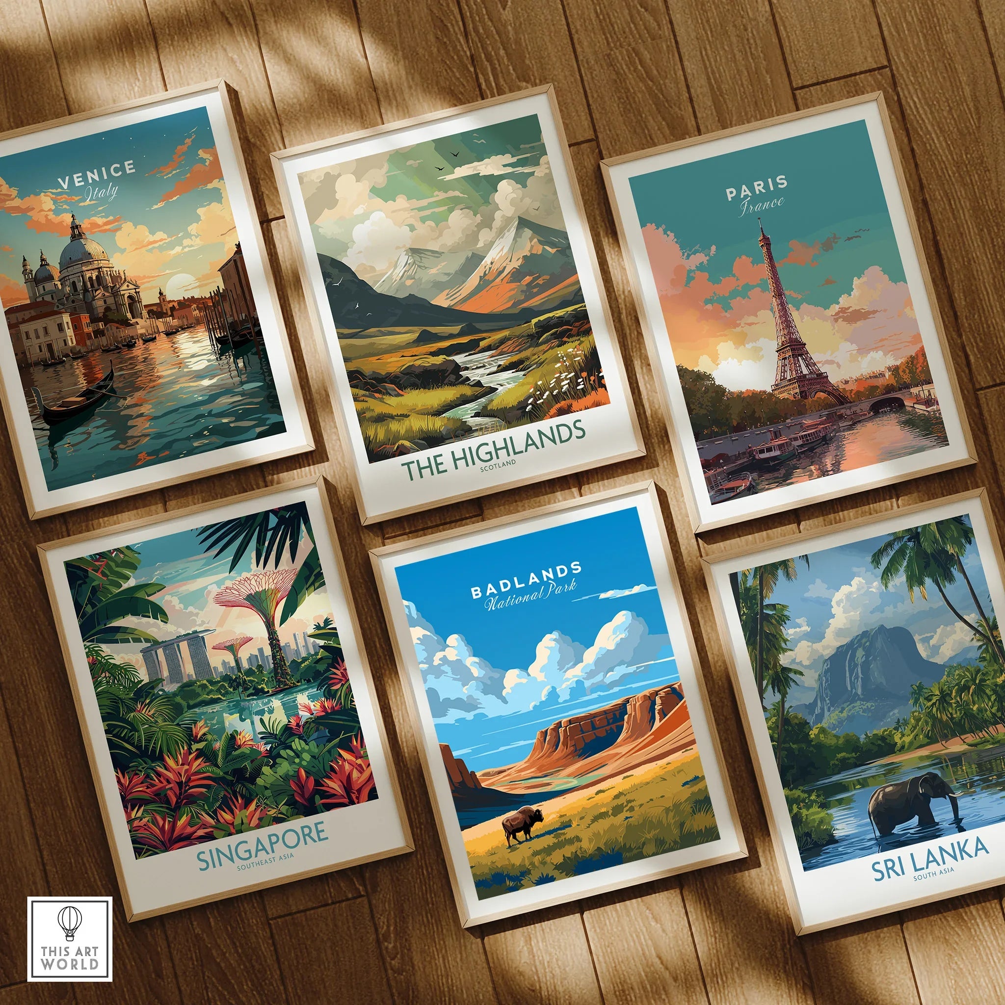 Set of six framed travel art prints featuring Venice, Paris, Badlands, Singapore, Highlands, and Sri Lanka, displayed on a wooden floor.
