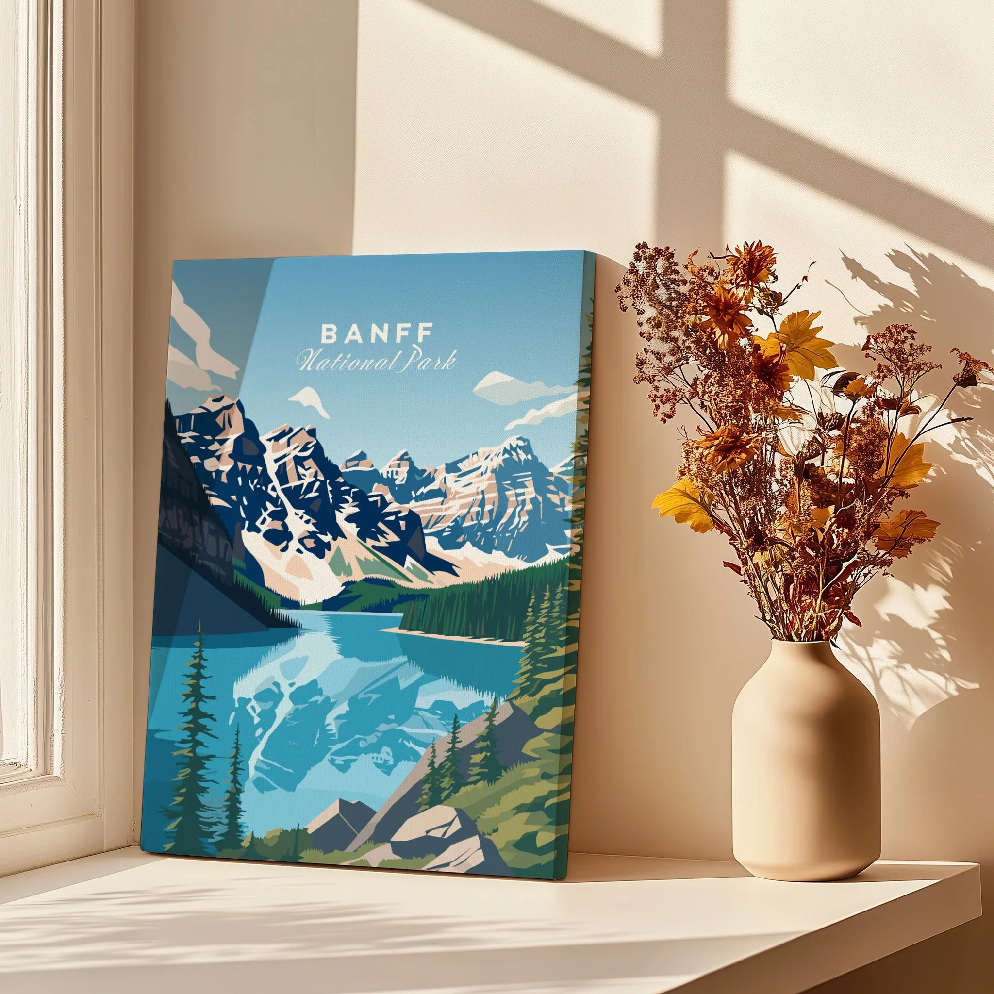 Banff National Park travel poster canvas with mountain lake design, next to vase of flowers in sunlight