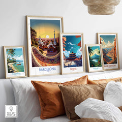 Framed art prints of Barcelona, Beijing, Costa Rica, Philippines, and Grand Canyon displayed on a modern sofa.