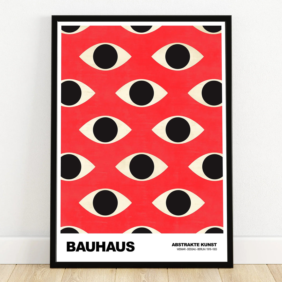 Bauhaus style abstract art print with black eye pattern on red background in black frame.