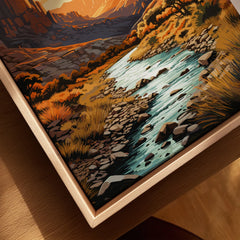 Closeup of a framed canvas art print featuring a scenic river landscape and mountains.