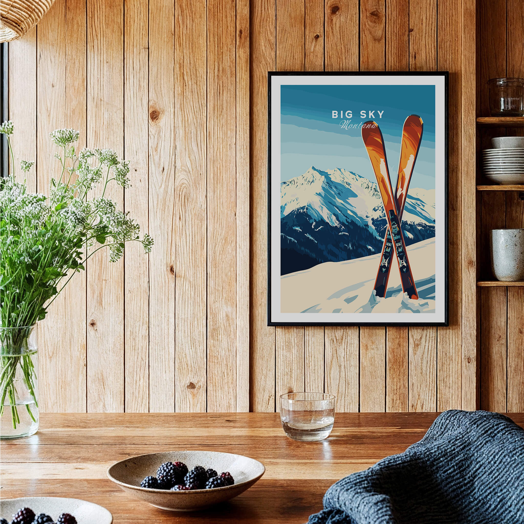 Big Sky Print Montana - Ski Poster framed on a wooden wall with skis and decorative plants.