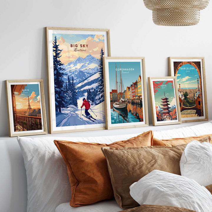 Big Sky Montana ski print poster displayed among framed travel art on a stylish bedroom wall with cozy pillows.