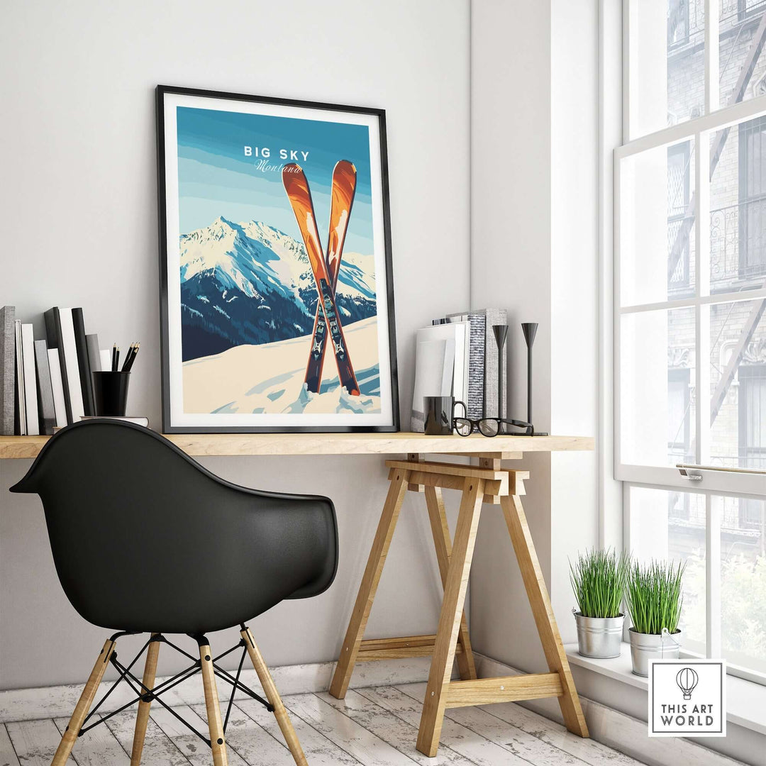 Big Sky Print Montana ski poster framed on a desk, featuring snowy mountains and stylish skis in a home office setting.