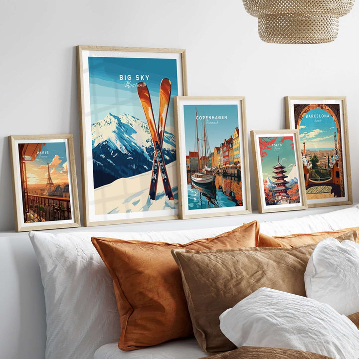 Big Sky Print Montana ski poster displayed with framed city posters on a stylish bed with decorative pillows.