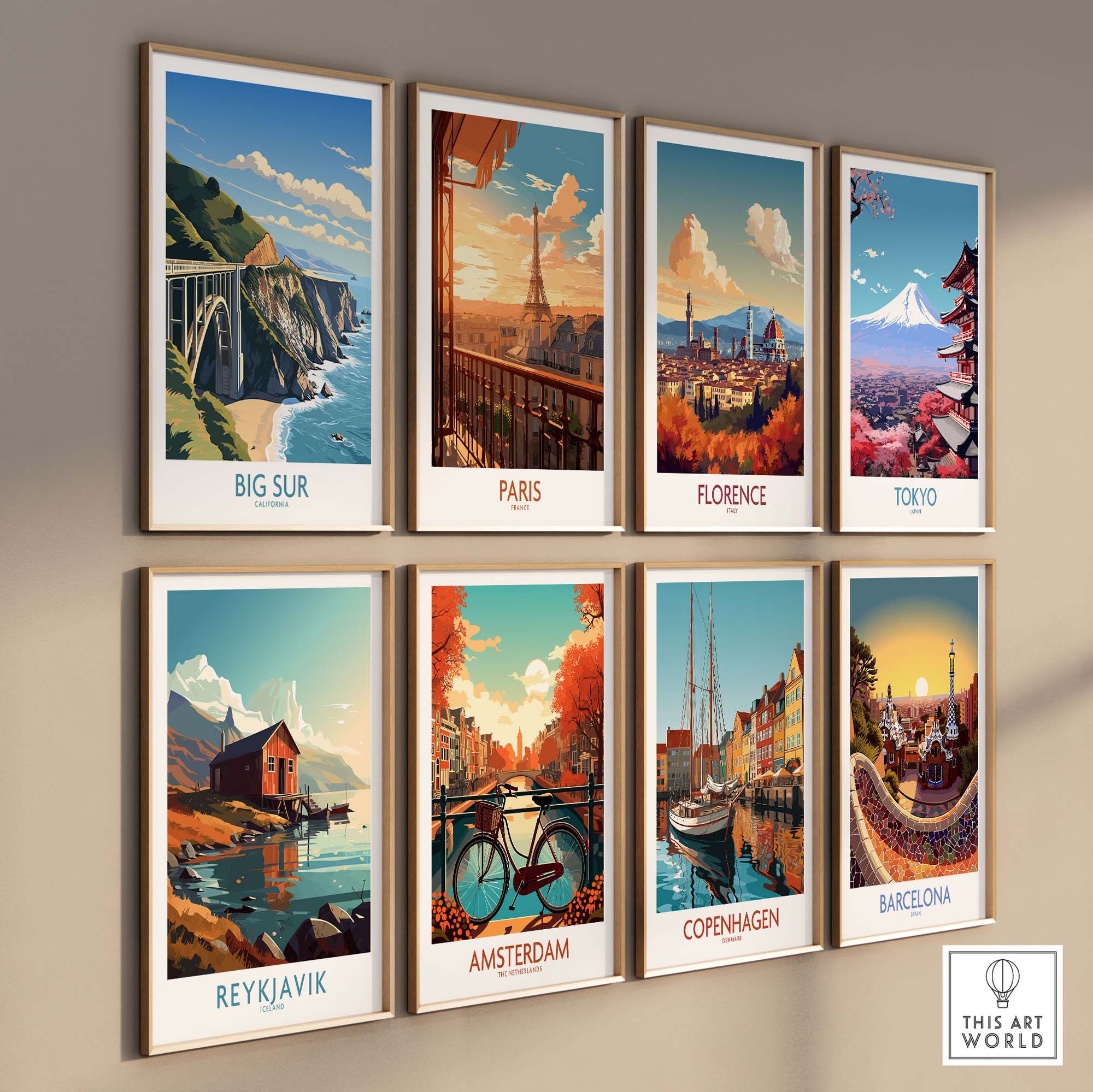 Gallery wall featuring modern travel art prints of Big Sur, Paris, Florence, Tokyo, Reykjavik, Amsterdam, Copenhagen, and Barcelona.