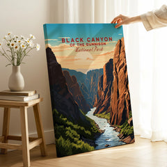 Hand holding Black Canyon of the Gunnison National Park canvas wall art in a bright room.