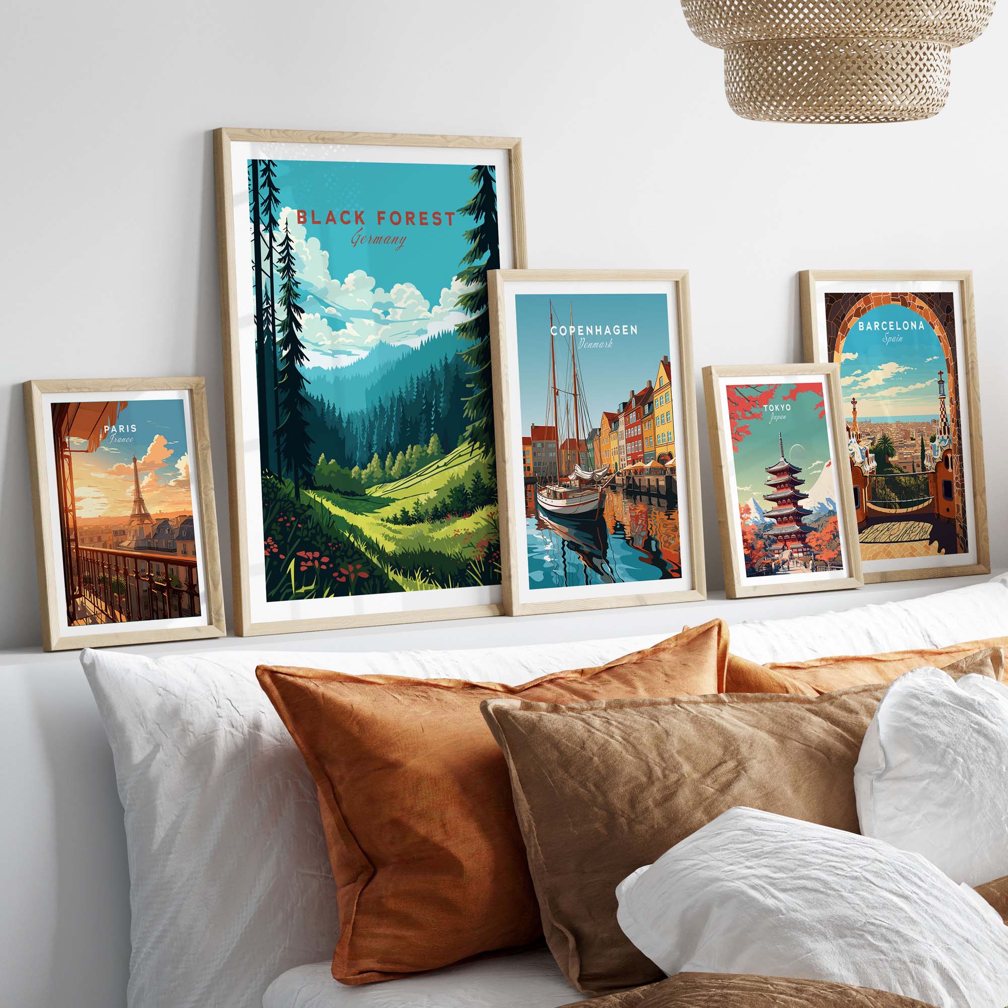 Framed Black Forest Poster Print showcasing scenic views of Germany and other travel destinations, displayed on a cozy couch.