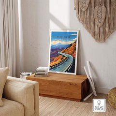 Blue Ridge Parkway poster displayed in a cozy room, featuring vibrant autumn colors and winding road scenery.