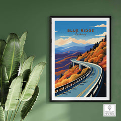 Blue Ridge Parkway poster featuring vibrant autumn colors and winding road, framed on green wall with plant.